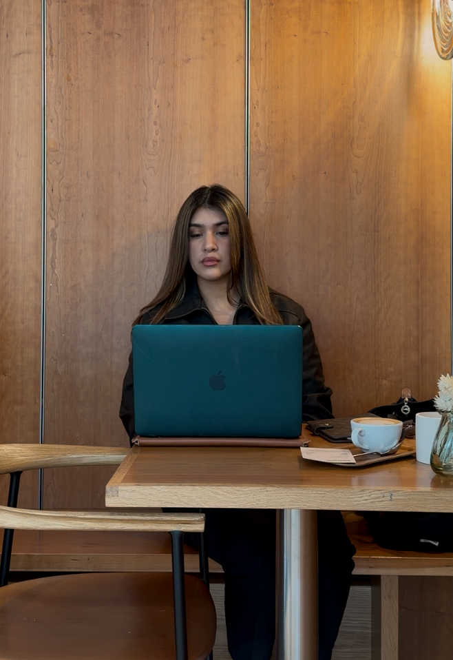 Founder Kay coding on a laptop